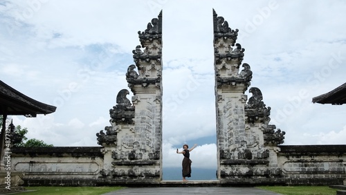 Embracing view on the famous Bali gates in cloudy weather, female tourist tacking selfie on wonderful scape