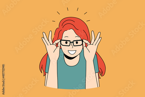 Eyewear and choosing eyeglasses concept. Smiling red haired girl trying on and choosing elegant eyeglasses in optic over orange background vector illustration 