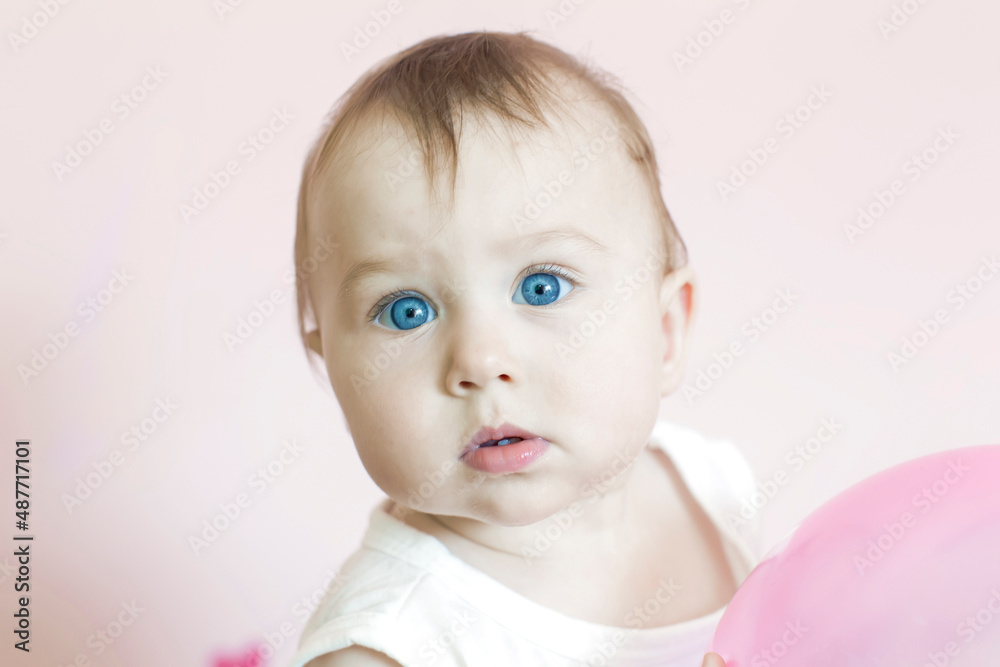 Studio apartment photo. One year old girl looks at the camera. Studio apartment photo. One year old girl looks at the camera.