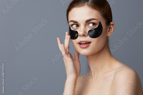 portrait woman eye patches on face bare shoulders skin care close-up Lifestyle
