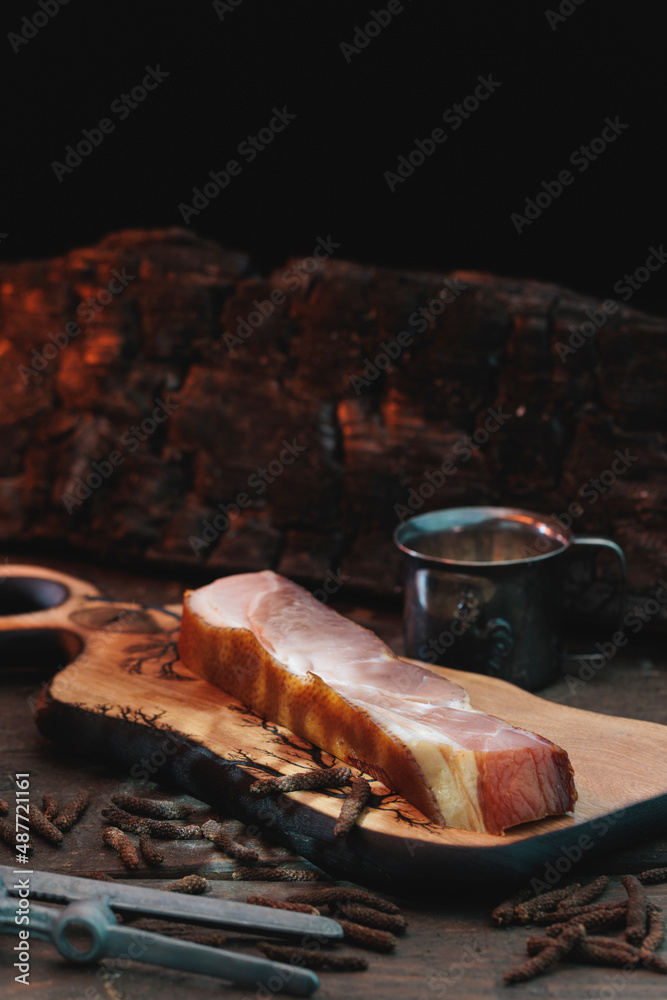 Raw pork neck smoked ham at home in smoker, traditionally rustic dish