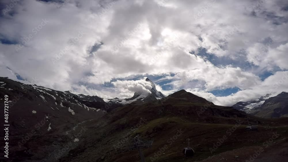 Accelerated clouds swirl over the mountain peak Accelerated clouds swirl over the mountain peak