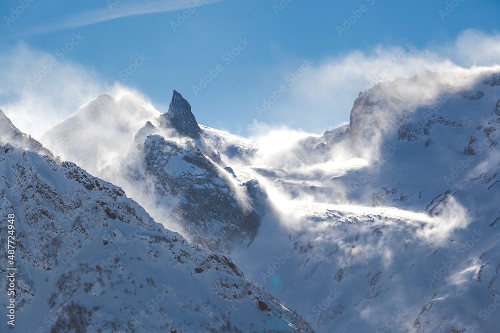 view of high mountains in the snow, strong wind in the mountains