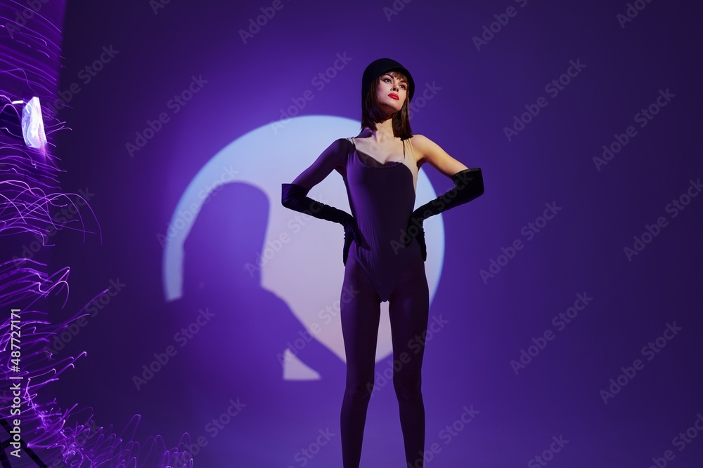 Portrait of a charming lady posing studio light neon purple background unaltered