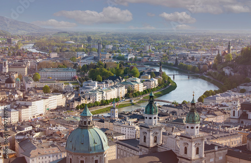 Panoramic view in a Spring season scene at a historic city of Salzburg with Salzach river in beautiful golden evening light sky at sunset, Salzburger Land, Austria.