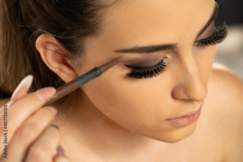 Beauty makeup. Woman shaping eyebrow with brow pencil closeup Beauty makeup. Woman shaping eyebrow with brow pencil closeup
