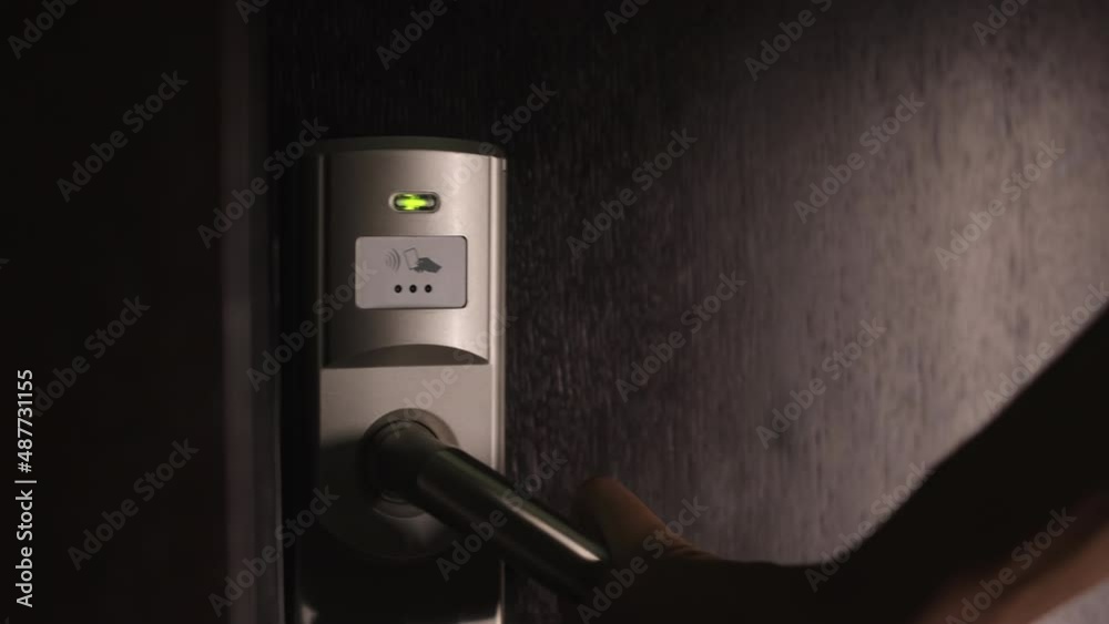 Female person using electronic keycard for opening door at modern hotel. Close up of woman entering her private room with security code. Female person using electronic keycard for opening door at modern hotel. Close up of woman entering her private room with security code.