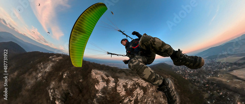 Man flying the paragliding at sunset, adventure concept