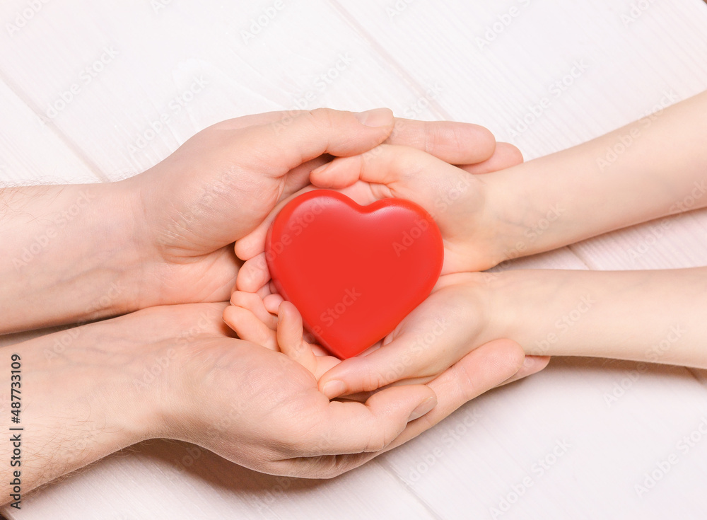 Man give red heart to kid as couple. Healthcare and hospital medical concept. Donation concept.Symbolic of Valentine day.Top view with space for text.