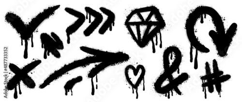 Set of black graffiti spray. Collection of arrow, dot, diamond, heart and symbols with spray texture and stencil pattern. Elements on white background for banner, decoration, street art and ads.