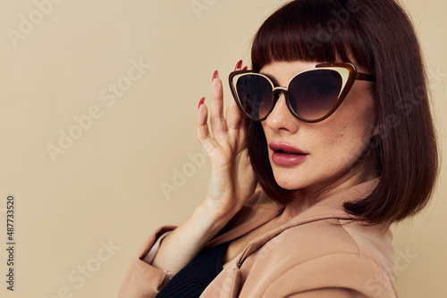 beautiful woman in a beige jacket elegant style sunglasses Lifestyle unaltered