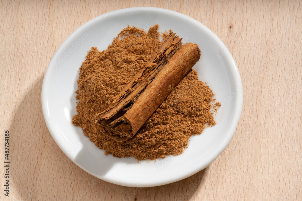 Detailed and large close up shot of cinnamon on a small plate Detailed and large close up shot of cinnamon on a small plate