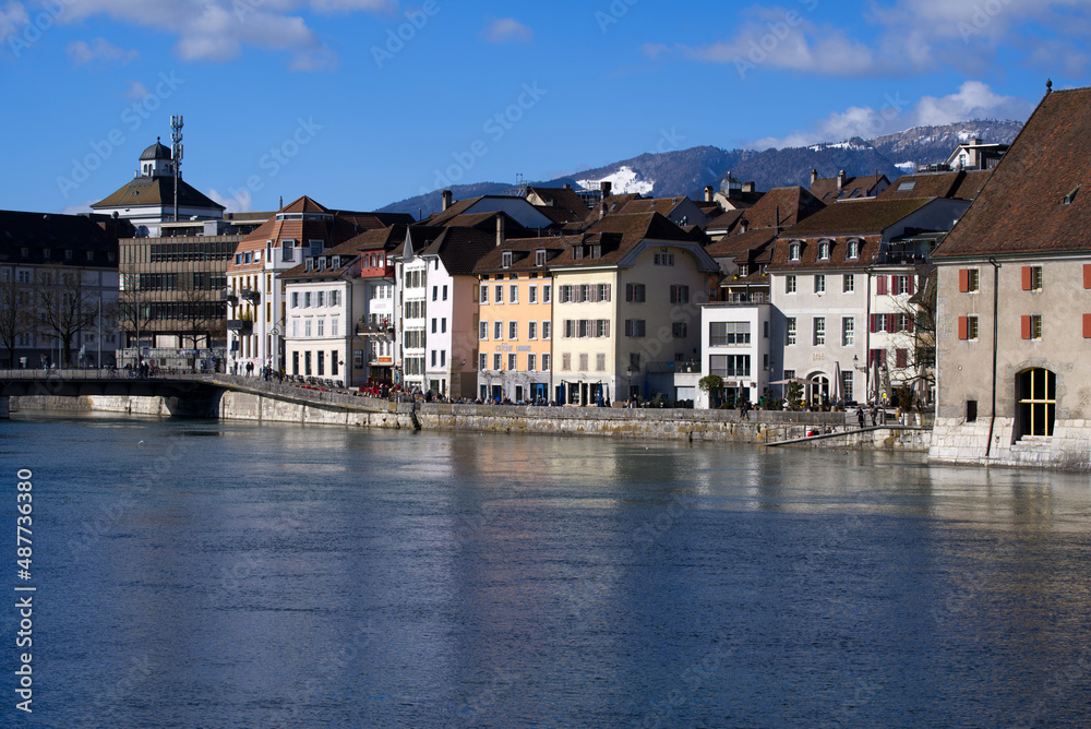 View at the old town of Solothurn seen form the Kreuzacker Bridge on a sunny winter day with river Aare in the foreground. Photo taken February 7th, 2022, Solothurn, Switzerland.