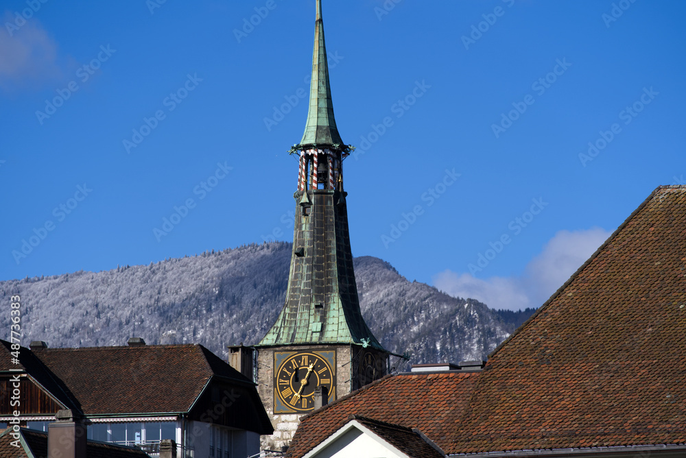 Clock tower at the medieval old town of Solothurn on a sunny winter day. Photo taken February 7th, 2022, Solothurn, Switzerland.