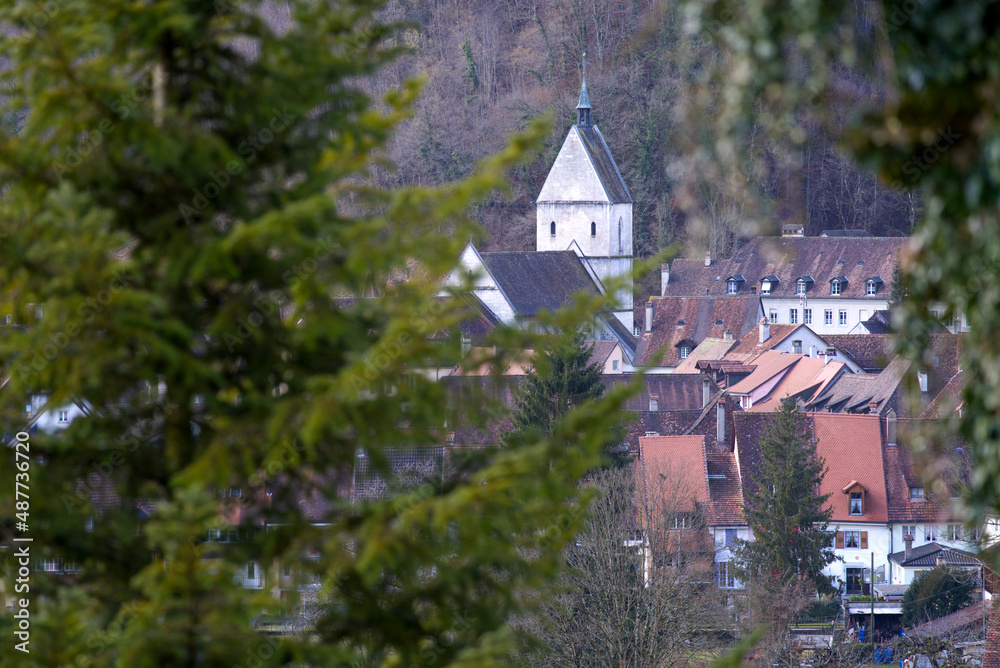 Aerial view of small medieval town St-Ursanne with focus on background on a cloudy winter day, focus on background. Photo taken February 7th, 2022, Saint-Ursanne, Switzerland.