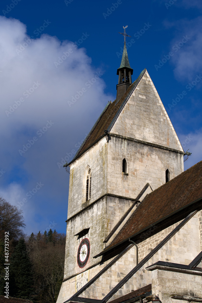 Fototapeta premium Beautiful collegiate church at little medieval town St-Ursanne, Canton Jura, on a sunny winter day. Photo taken February 7th, 2022, Saint-Ursanne, Switzerland.