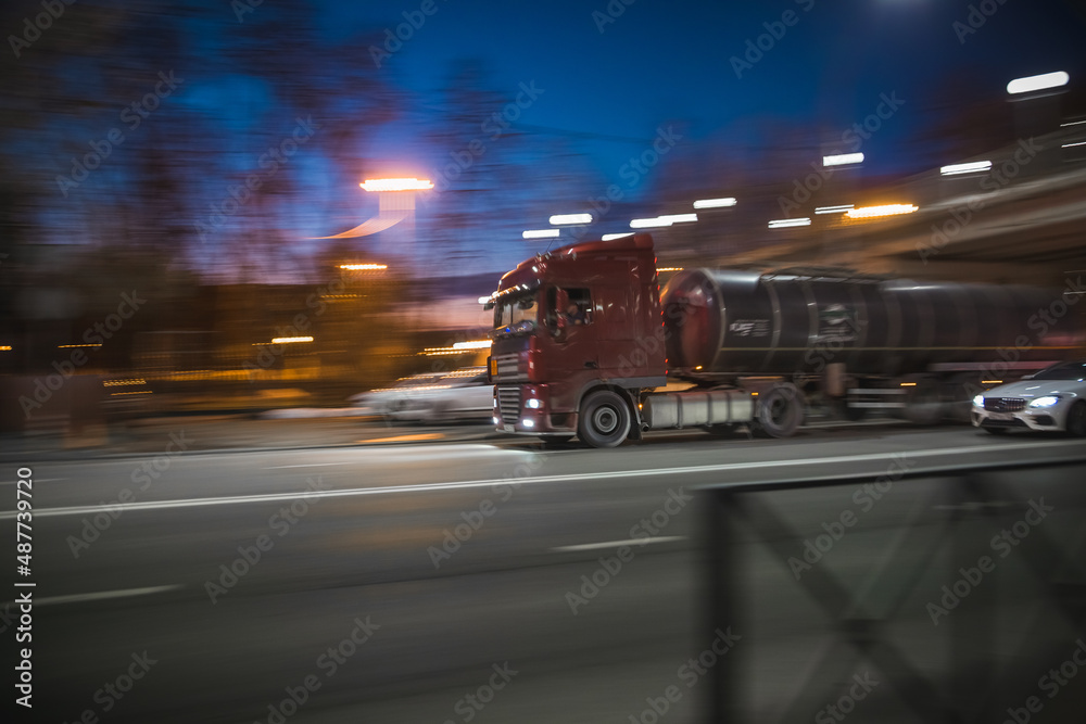 Fototapeta premium a truck drives fast through city streets