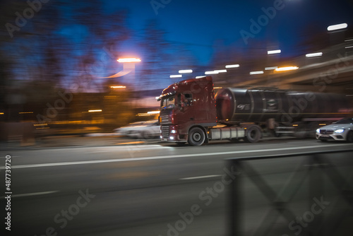 a truck drives fast through city streets