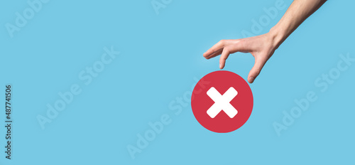 Foto Hand holds icon,cancellation symbol,cancel icon