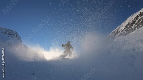 High speed ski turns on a steep ski slope in a glacier ski resort high up in the alps with fresh snow. Panorama skiing with the best mountain. Cinematic slow motion skiing in winter. 4K PRORES 422