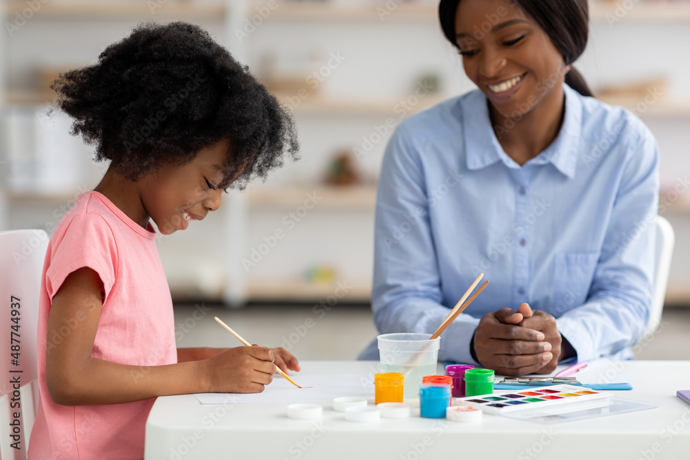Cute african american little girl drawing at daycare Cute african american little girl drawing at daycare