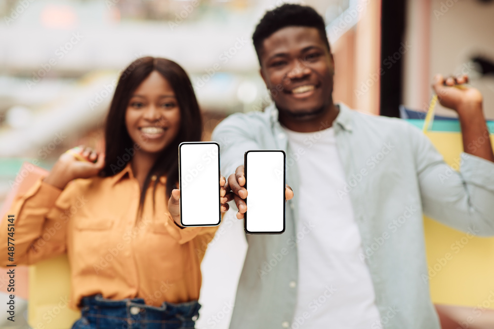 Black couple showing blank empty smartphone screen for mockup