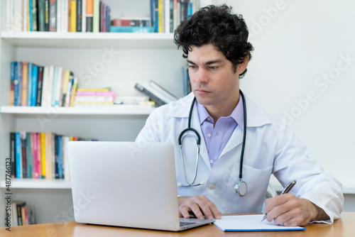 Caucasian doctor or scientist working at desk at office