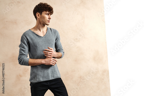 Фотография Portrait of young man in profile face over grungy wall