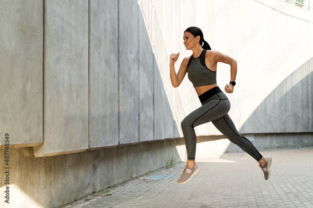 Cheerful energetic young jogger floating in air Cheerful energetic young jogger floating in air
