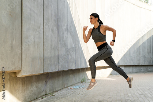 Cheerful energetic young jogger floating in air
