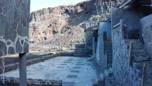 Aerial dolly between the volcanic walls of houses Pozo de Las Calcosas photo