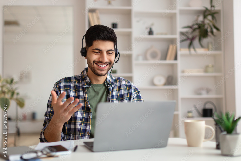 Arab man having video call using laptop and talking Arab man having video call using laptop and talking