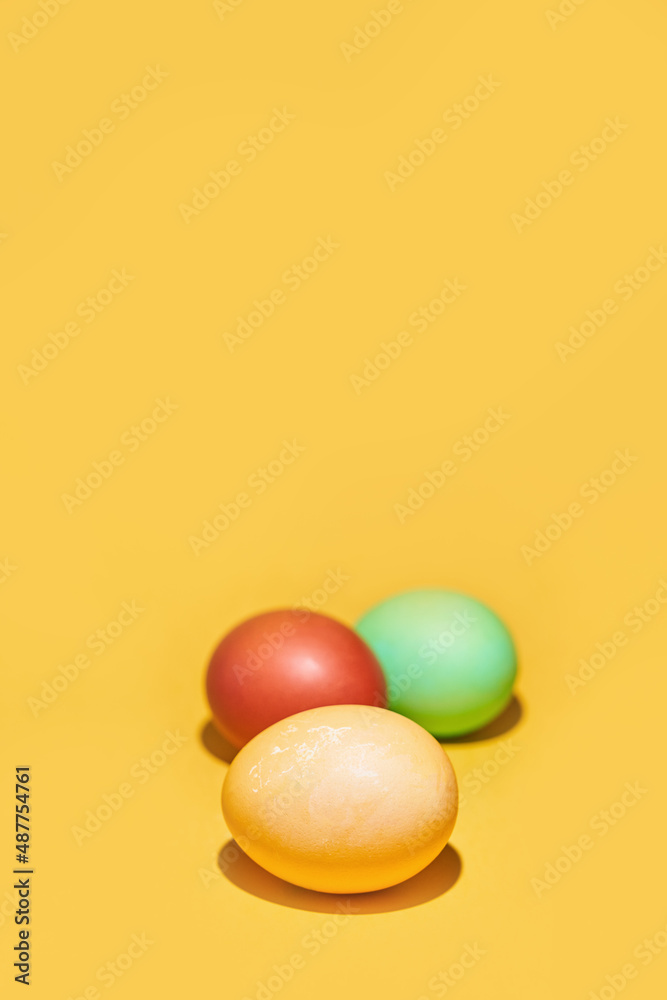 Painted Easter eggs on a yellow background. With space to copy. High quality photo