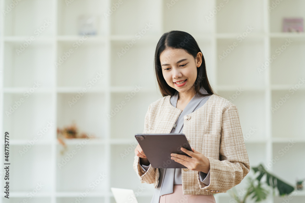 Portrait of successful businesswoman holding digital tablet during quick break in front a corporate building. Portrait of successful businesswoman holding digital tablet during quick break in front a corporate building.