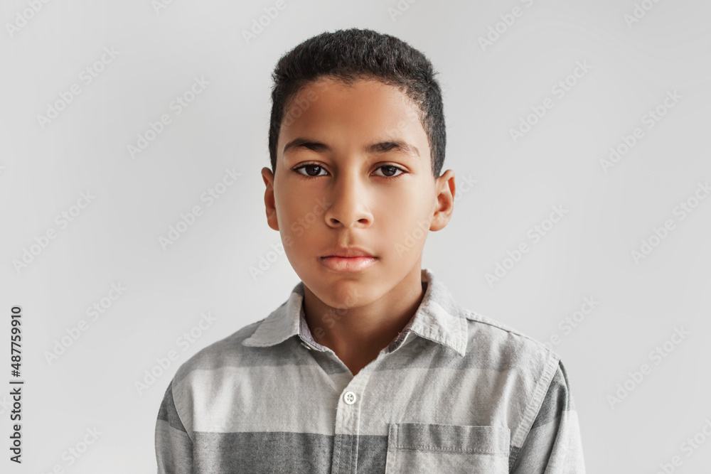 Obraz premium Headshot Of Serious African American Preteen Boy On Gray Background