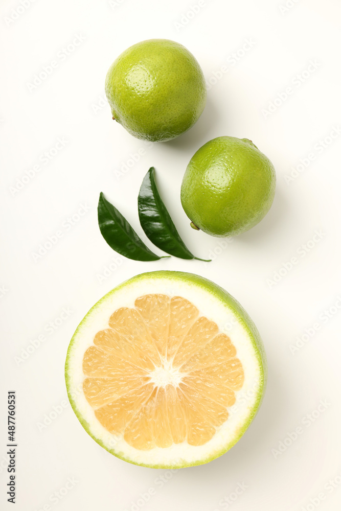 Limes with leaves on white background, top view