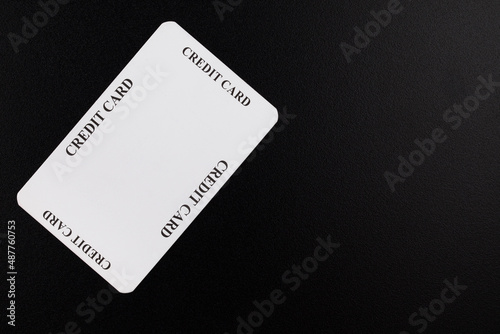 Credit Card Imitation. White cardboard box with the words "credit card" written on it, lying on a black background.