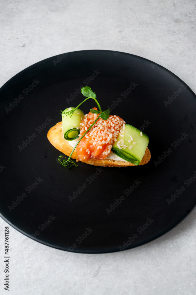 Mini sandwich for a buffet with salmon, cucumber and herbs Mini sandwich for a buffet with salmon, cucumber and herbs