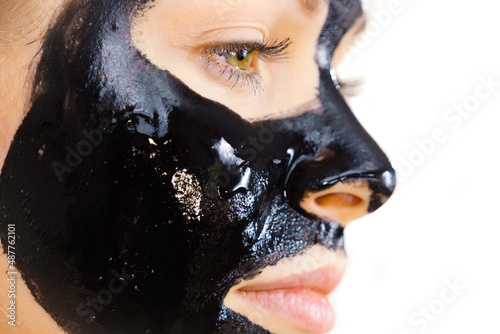Fotografie Woman with black peel off mask on face