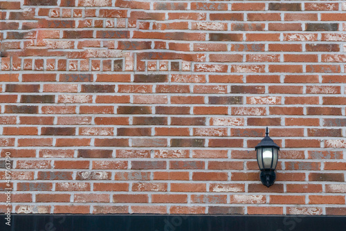 Street lamp installed in bricks mixed with red, apricot and gray