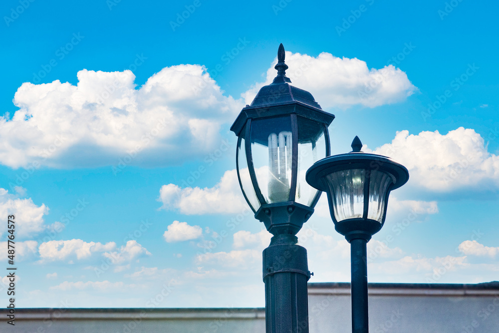 A street lamp installed on a veranda in cloudy and sunny weather