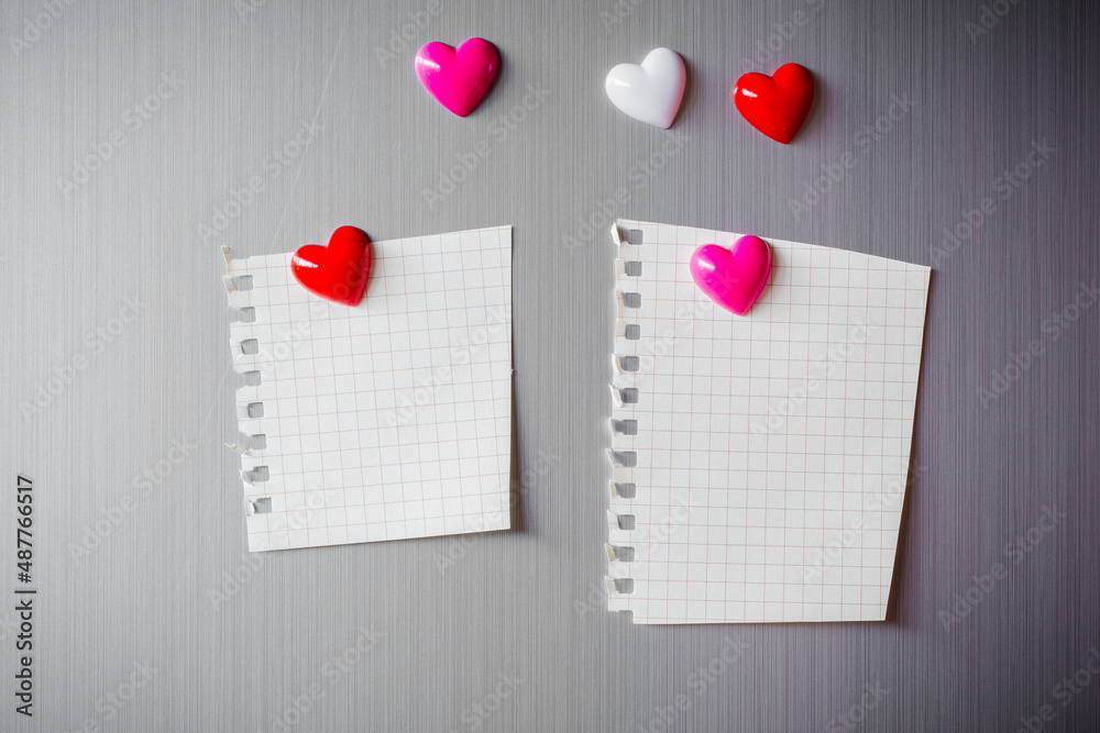 Abstract of wooden heart clip with Blank paper and stick paper on refrigerator door. paper note copy space for add text. valentine picture message background Abstract of wooden heart clip with Blank paper and stick paper on refrigerator door. paper note copy space for add text. valentine picture message background