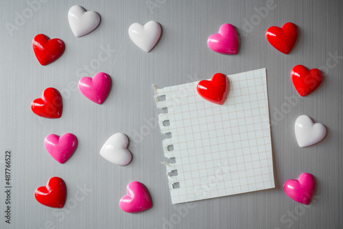 Abstract of wooden heart clip with Blank paper and stick paper on refrigerator door. paper note copy space for add text. valentine picture message background