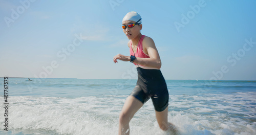 Obraz na plátně woman training triathlon at beach