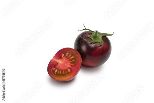 Three 3 black tomatoes cultivars isolated on white background. Various shapes of tomatoes. photo