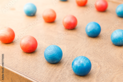 Mind game with colorful wooden balls close up