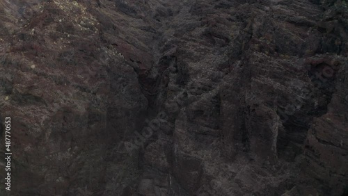 Aerial slider descent near cliff showing layers of formation periods