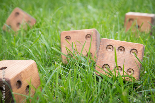 Wooden dice for outdoors games in the grass 