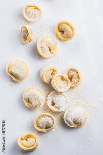 Raw fresh dumplings , or italian tortellini pasta, isolated on white background