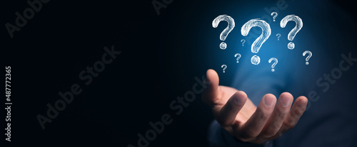 Businessman hand hold interface question marks